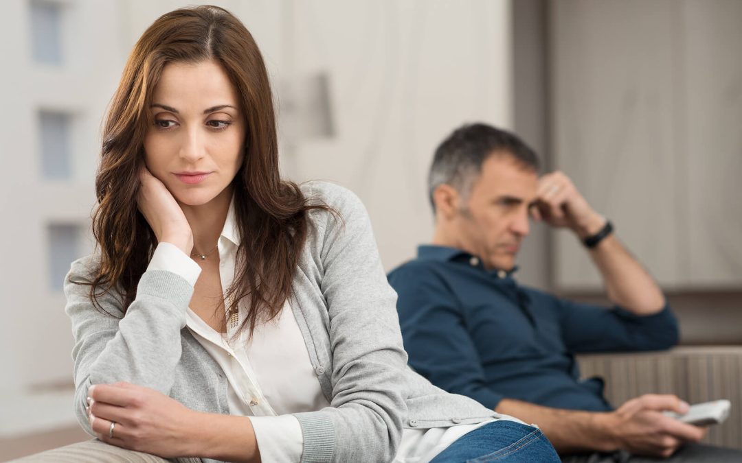 Image of an upset couple sitting on a couch facing away from each other. With the help of EMDR therapy in Wake Forest, NC you and your partner can begin to break unhealthy relationship patterns.