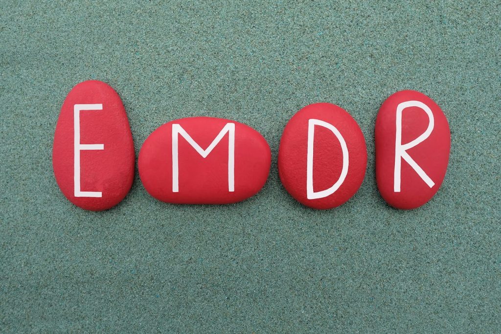 Image of red rocks spelling out emdr. If you find yourself struggling to overcome trauma, find support in healing with EMDR therapy in Raleigh, NC.