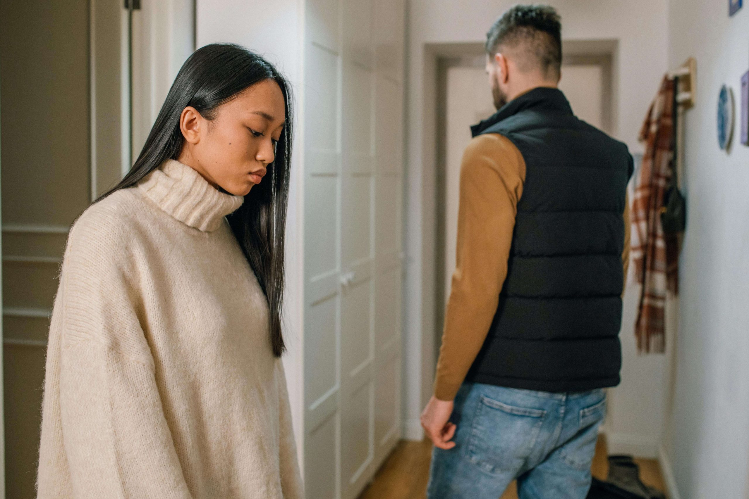 Image of a sad couple standing in a kitchen. If you and your partner struggle with relationship trauma, discover how EMDR therapy in Raleigh, NC can help you heal.