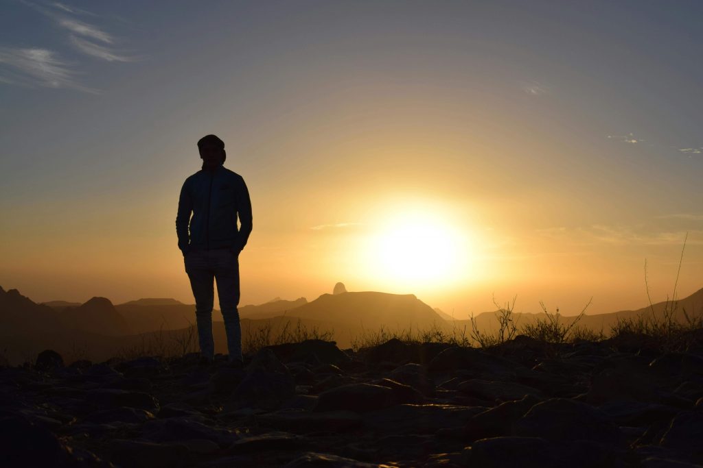 Lonely man standing outside as the sun rises. If you are struggling to cope with a single traumatic event, find support healing with EMDR therapy in Raleigh, NC.