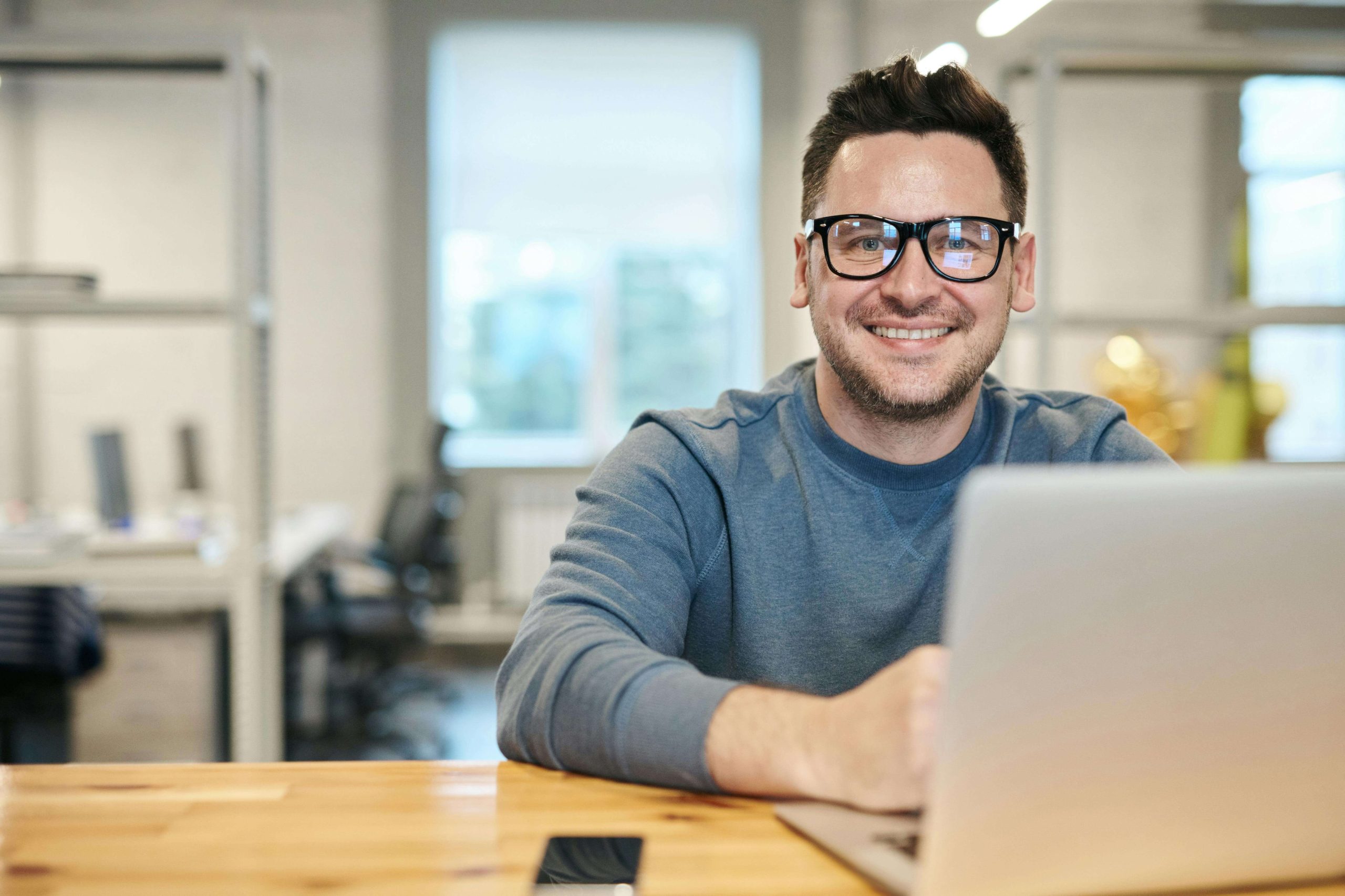 happy man with laptop | emdr therapy in raleigh, nca | emdr therapist | emdr therapy for ptsd | emdr trauma therapy | Boylan Heights | Brier Creek | Wakefield Happy man sitting at a desk in front of a laptop. Heal from your PTSD by coping in positive ways with the support of EMDR therapy in Raleigh, NC.